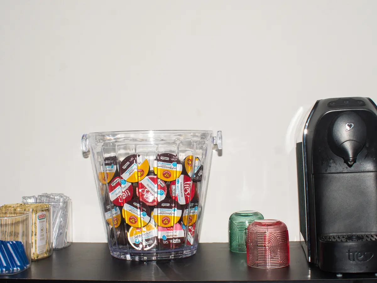 Cafeteira e cápsulas de café por conta da casa