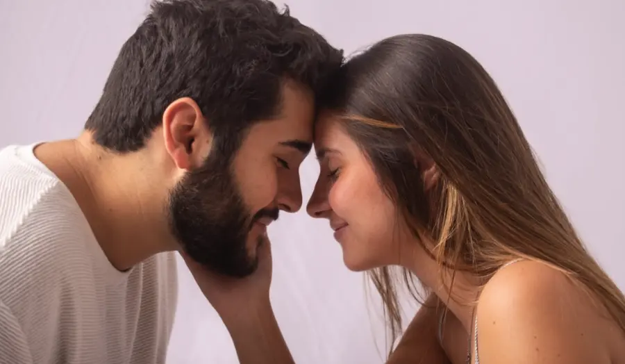 Casal com as testas encostadas em ensaio no estúdio